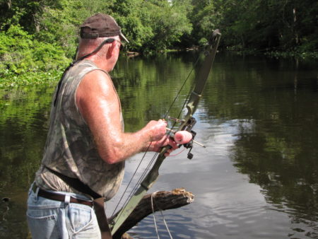 Roger Gunter bowfishing for gar fish. 